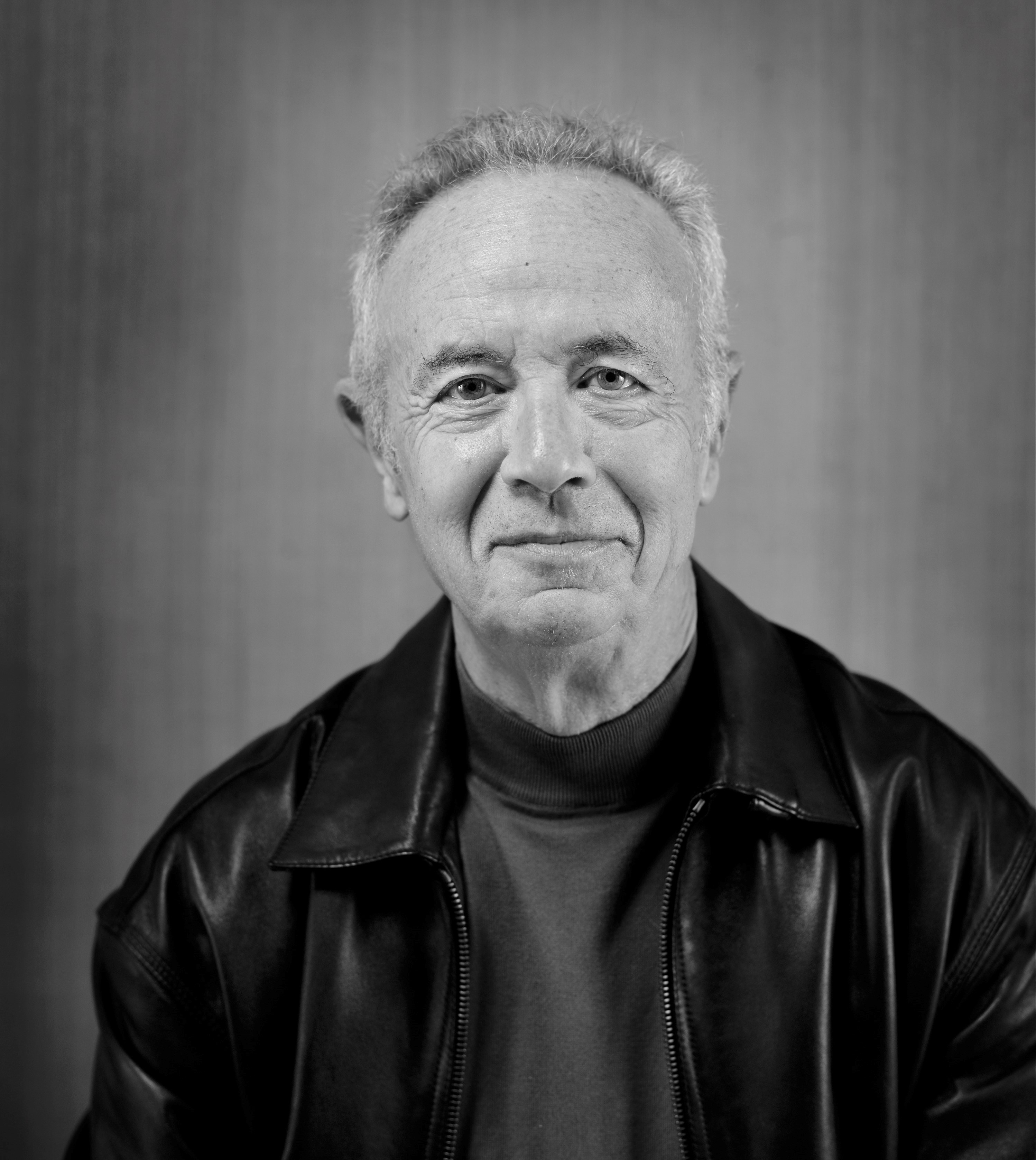 Headshot of Andy Grove wearing a leather jacket and a pleasant expression.