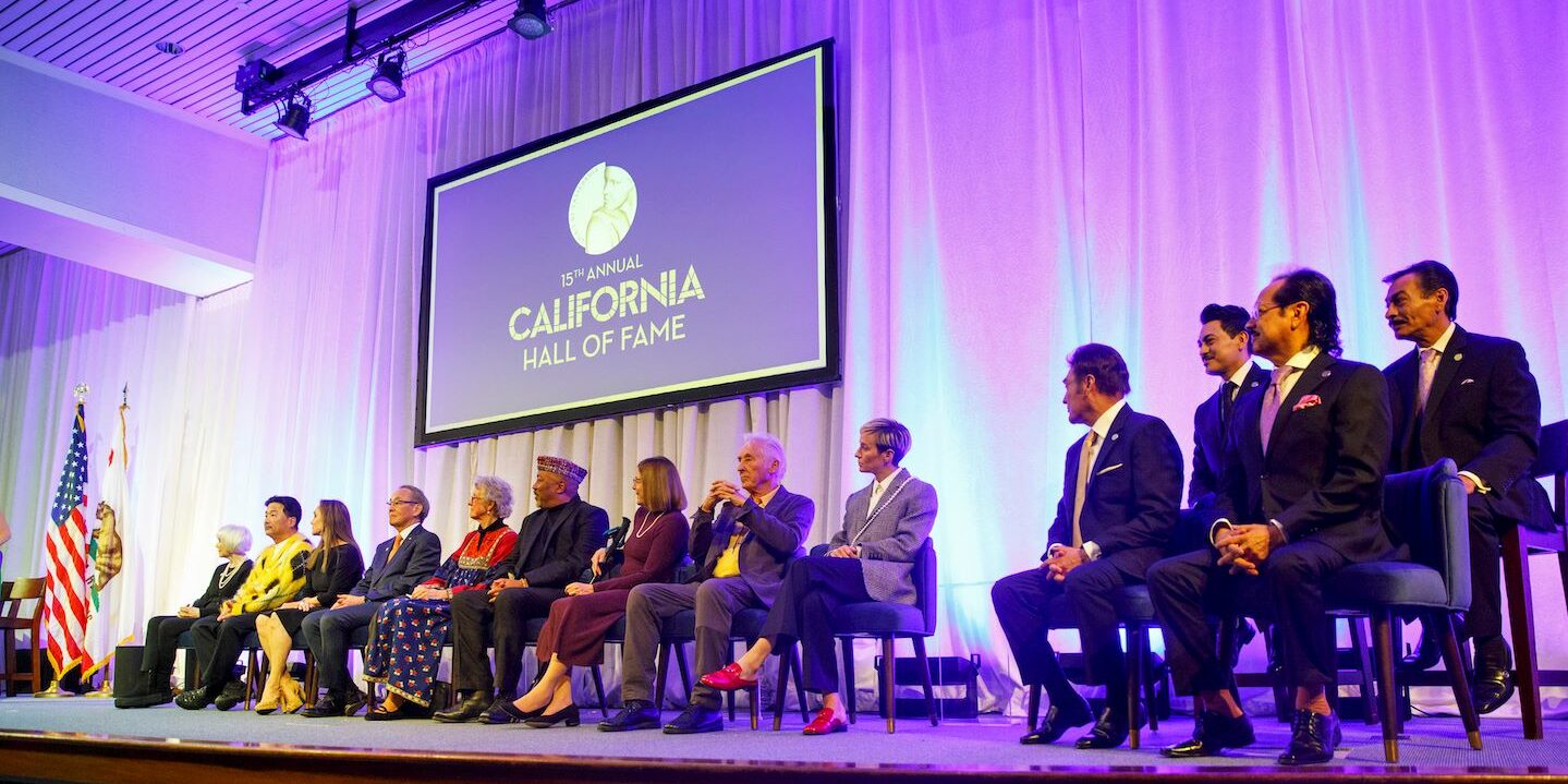 The 15th class of the California Hall of Fame sits onstage during their induction ceremony.