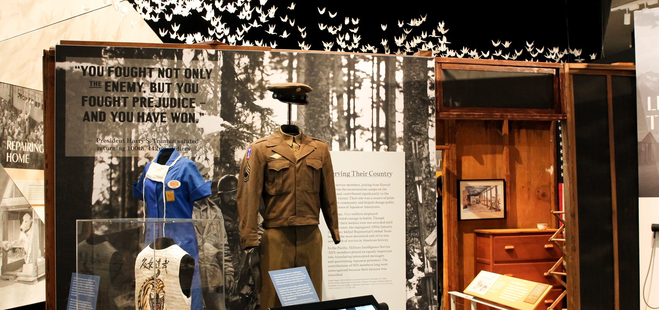 Military uniforms displayed in Uprooted exhibit