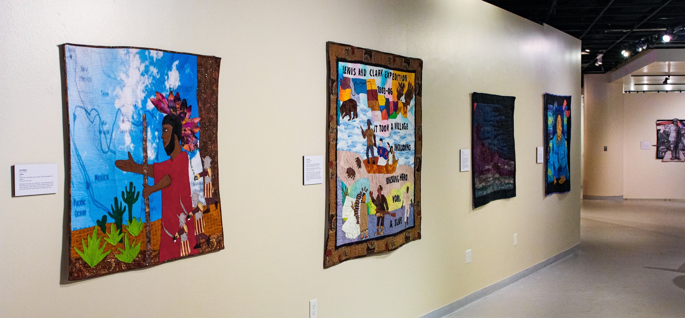 A gallery of art quilts in the Black Pioneers exhibit.