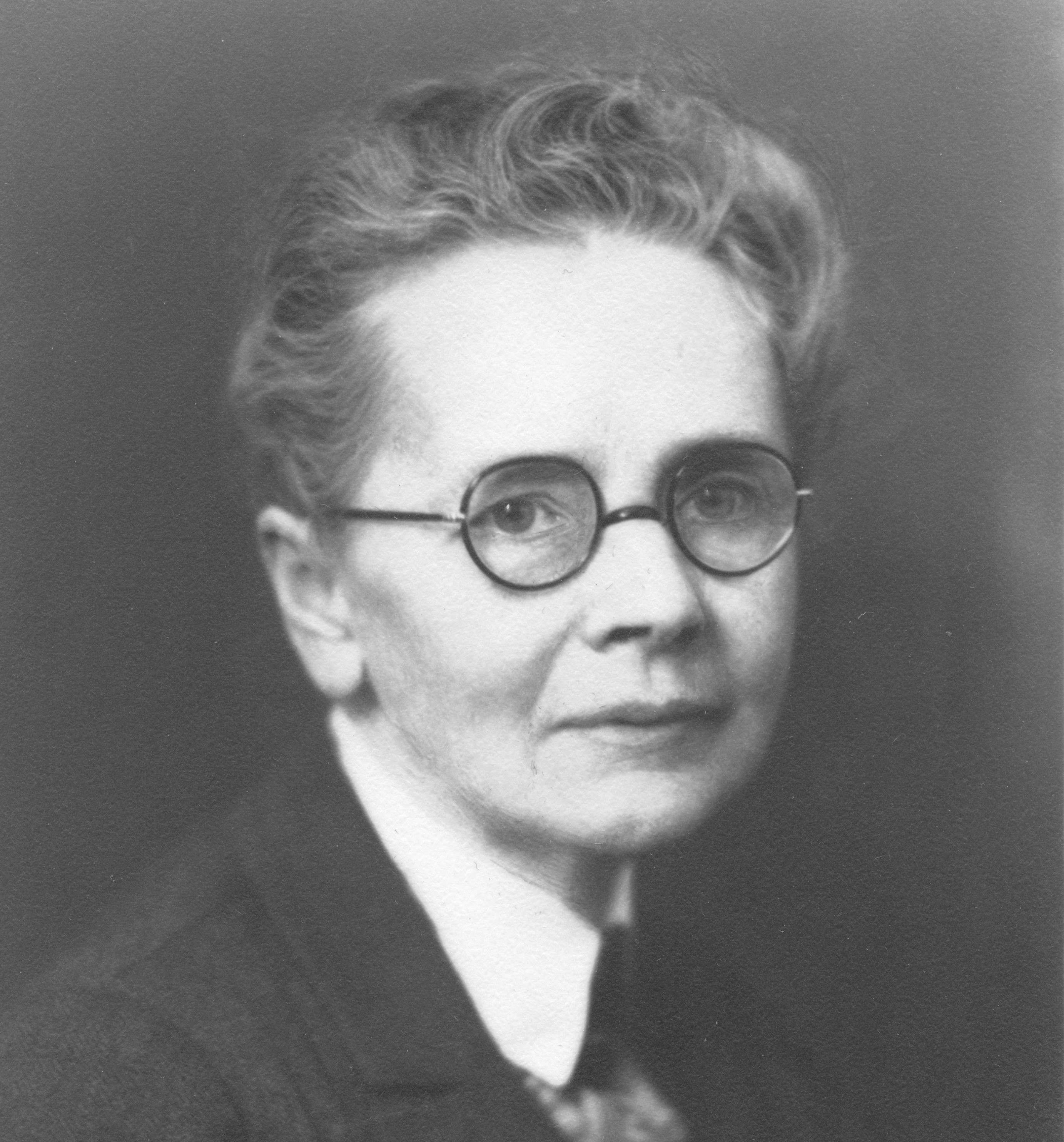 Headshot of Julia Morgan wearing glasses and a suit jacket.