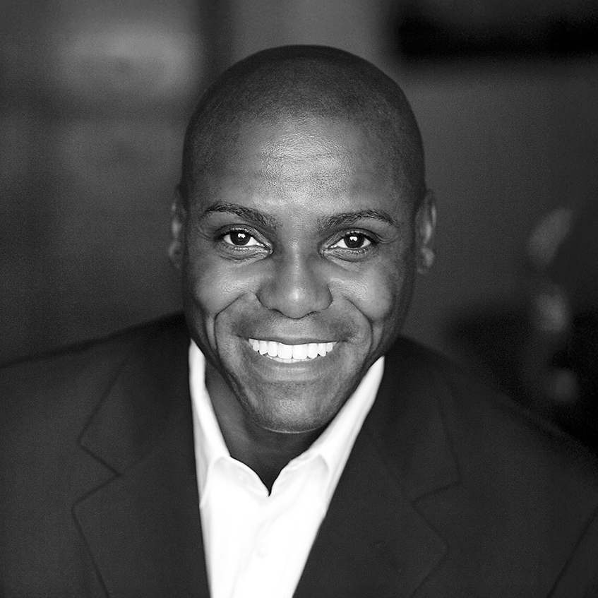 Carl Lewis smiles at the camera