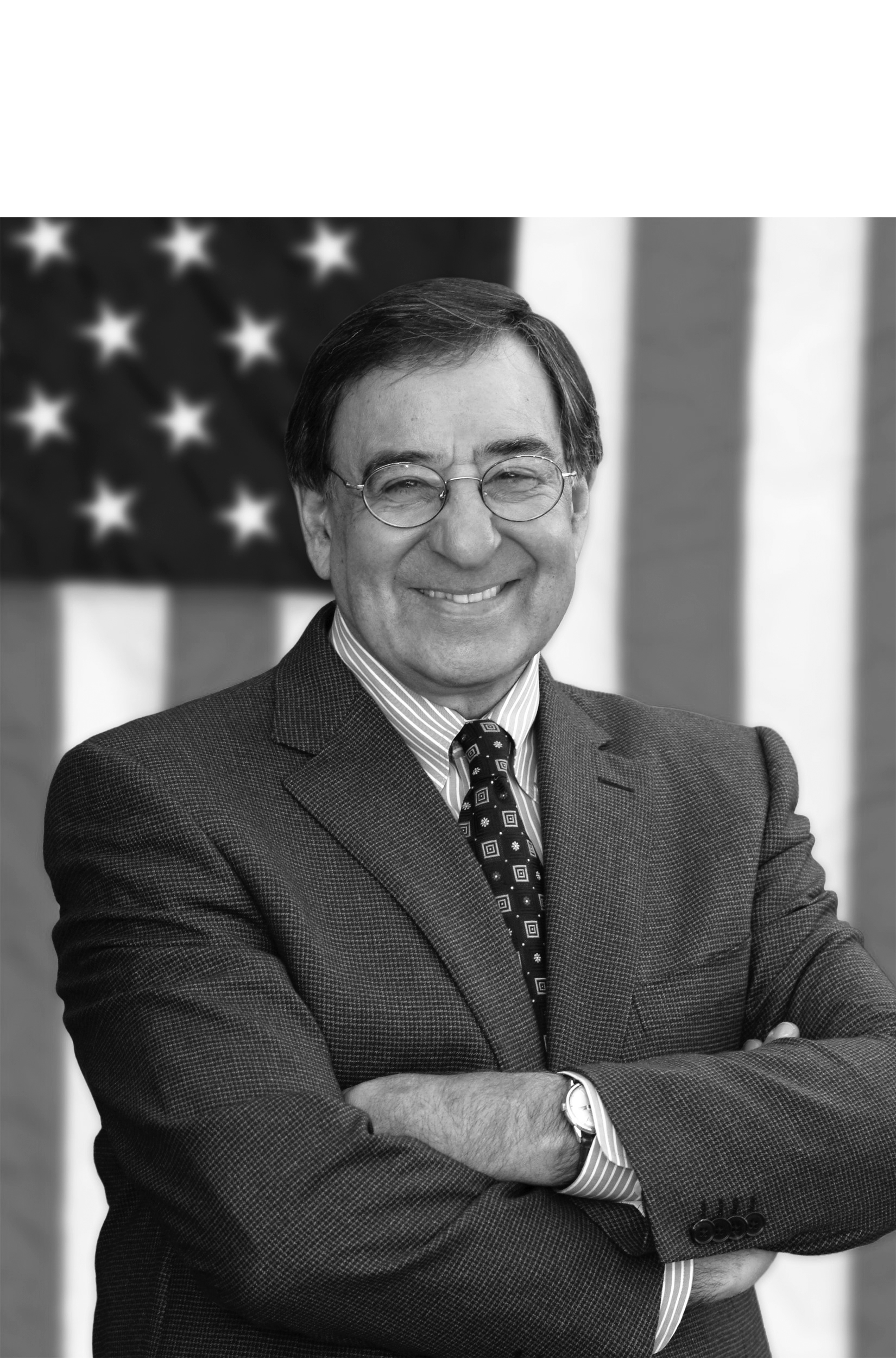 Leon Panetta poses with a smile in front of the American flag.