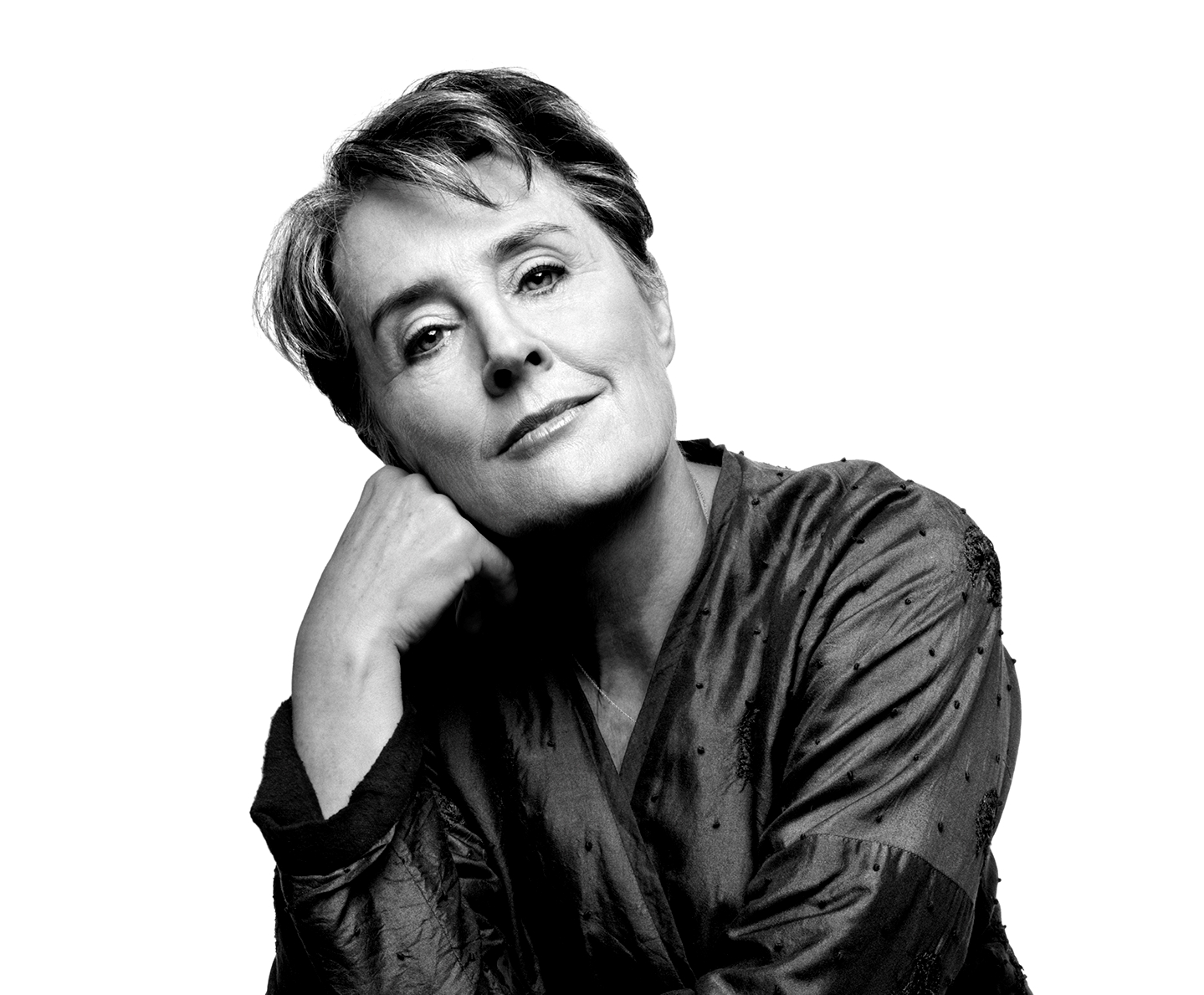 Headshot of Alice Waters with a soft gaze and a hand on her cheek.