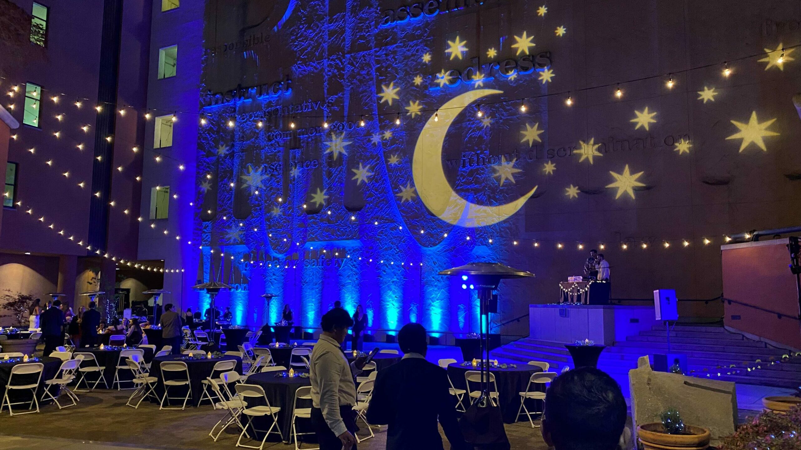 The moon and stars projected on the Constitution Wall during a night time event in the museum courtyard.