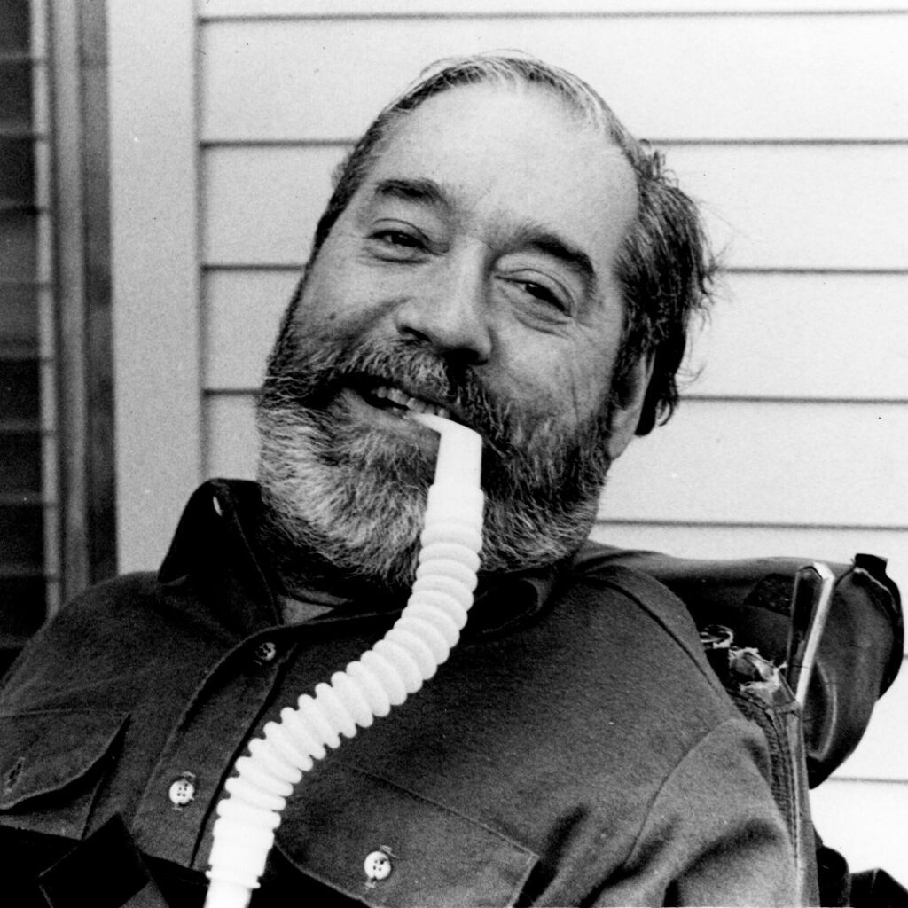 Headshot of a smiling Ed Roberts with his ventilator.