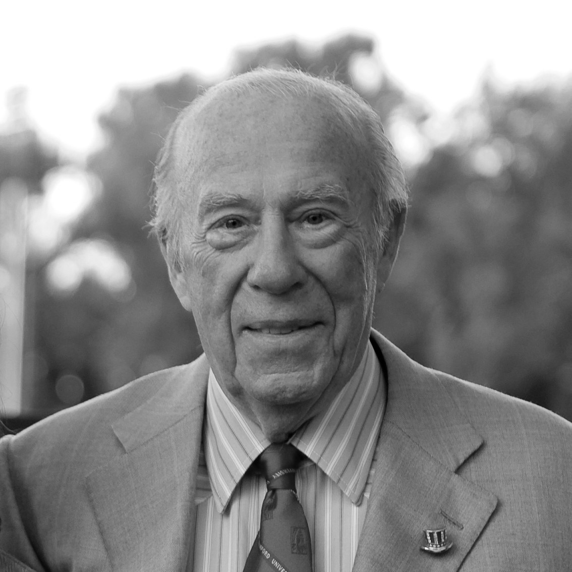 Headshot of George Schultz wearing a suit and tie.