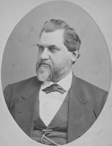 A vignette of Leland Stanford wearing a tuxedo and gazing to his side.