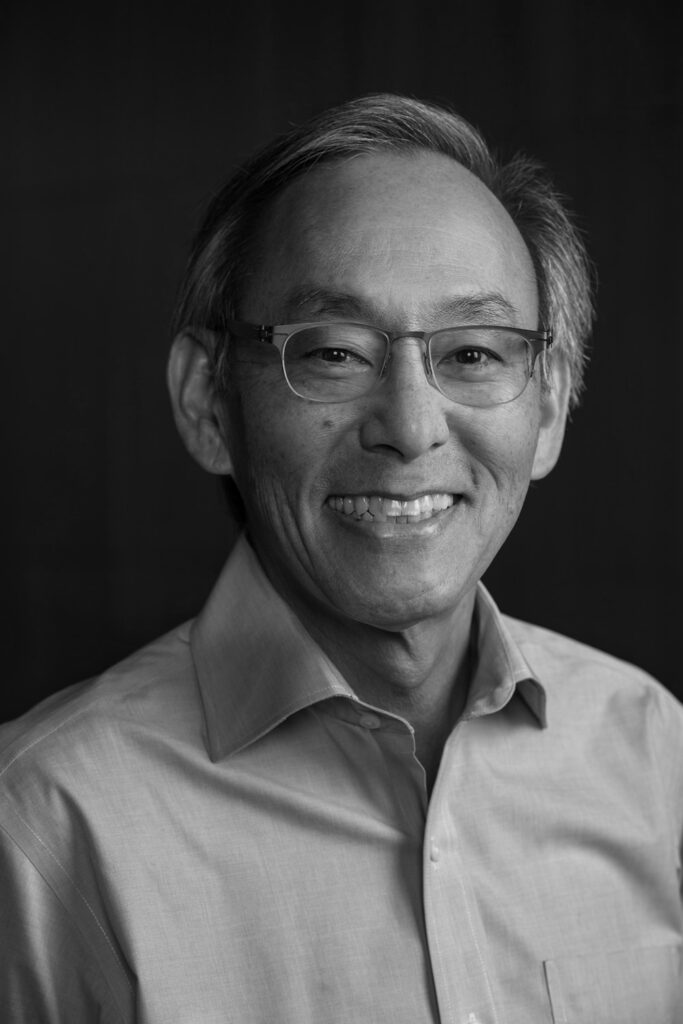 Headshot of a smiling Steven Chu in a button-up shirt.