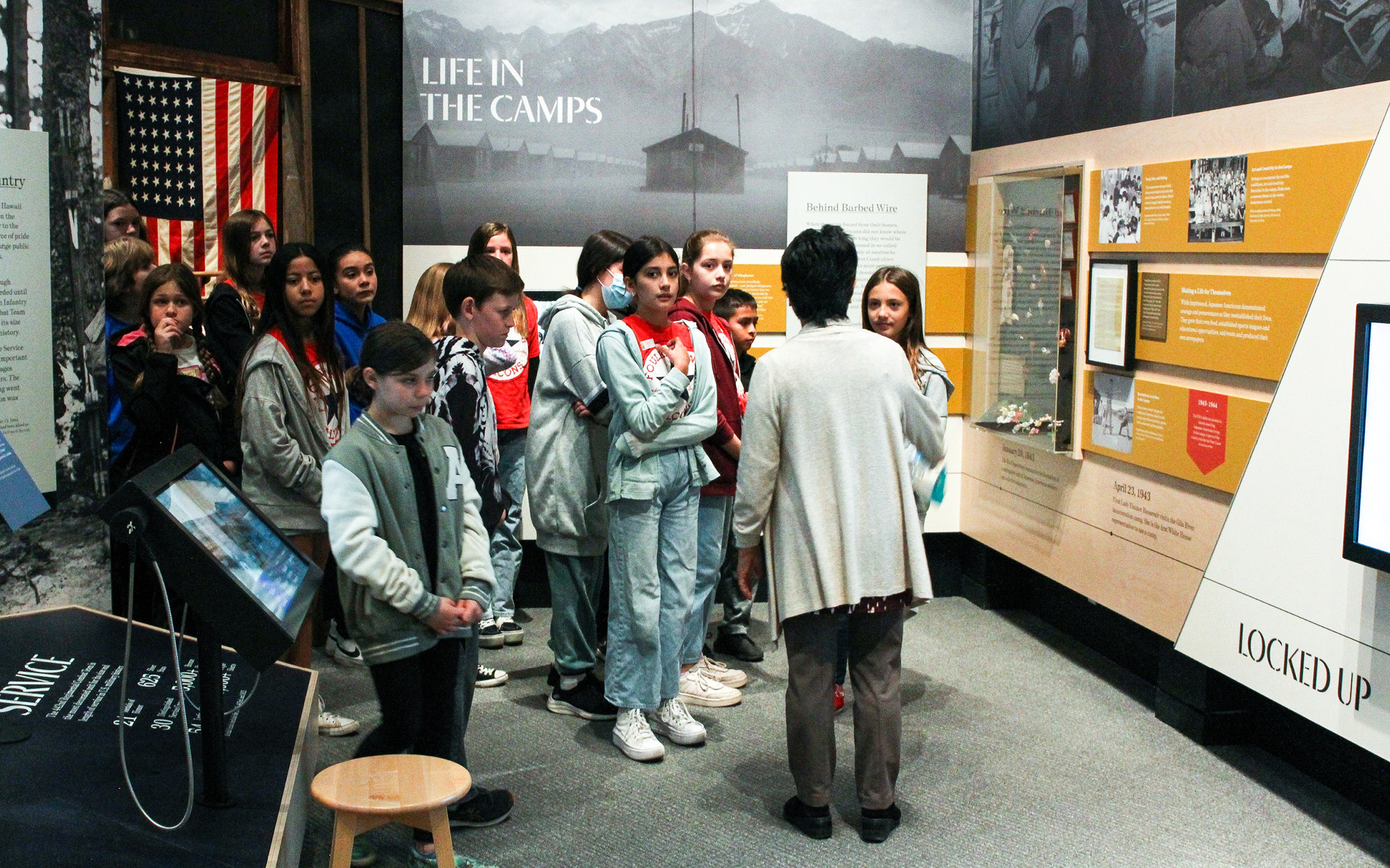 A museum docent leads a school tour.