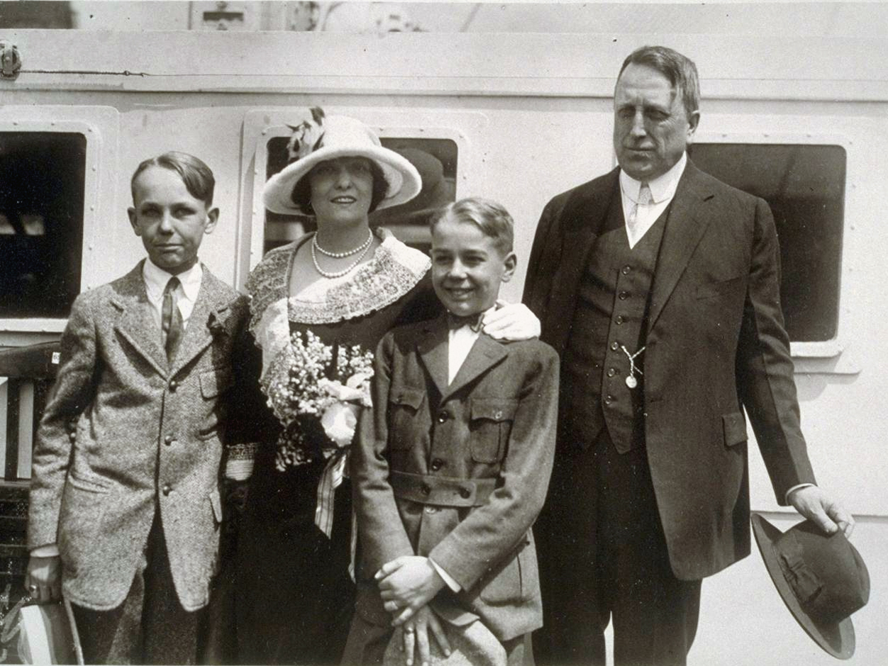Mr. and Mrs. Hearst pose with two of their sons in formal attire.