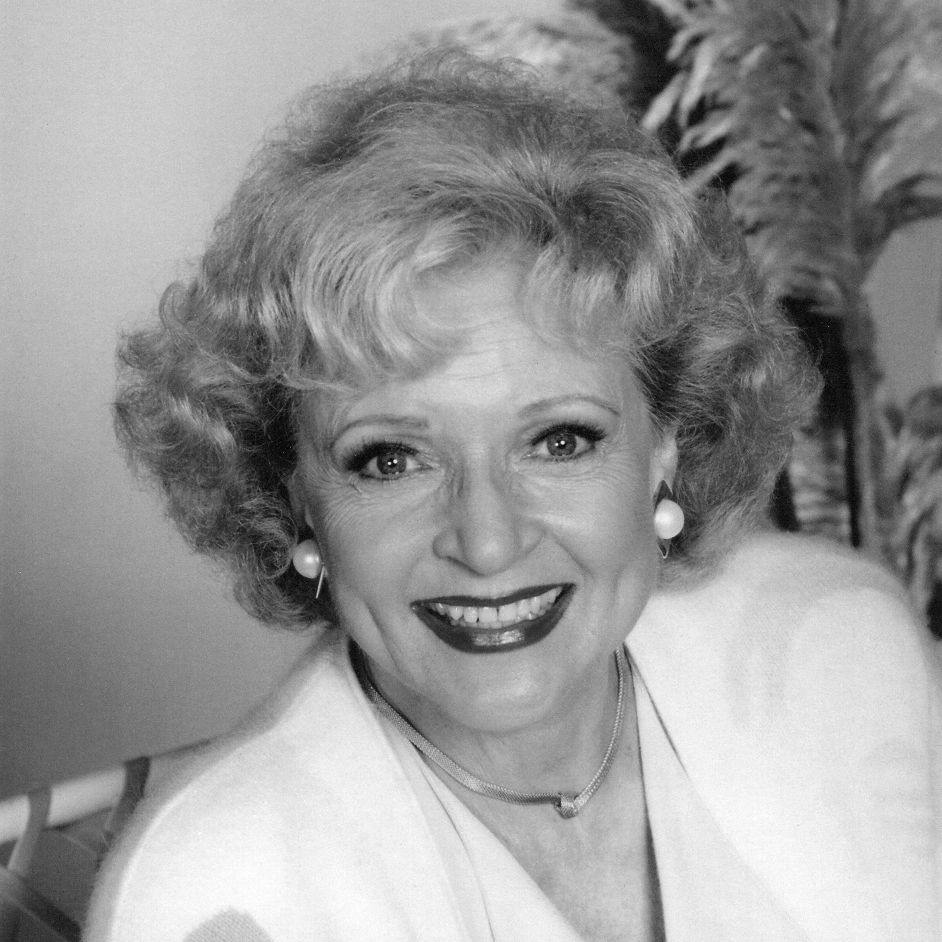 Headshot of a grinning Betty White wearing a bright lipstick.