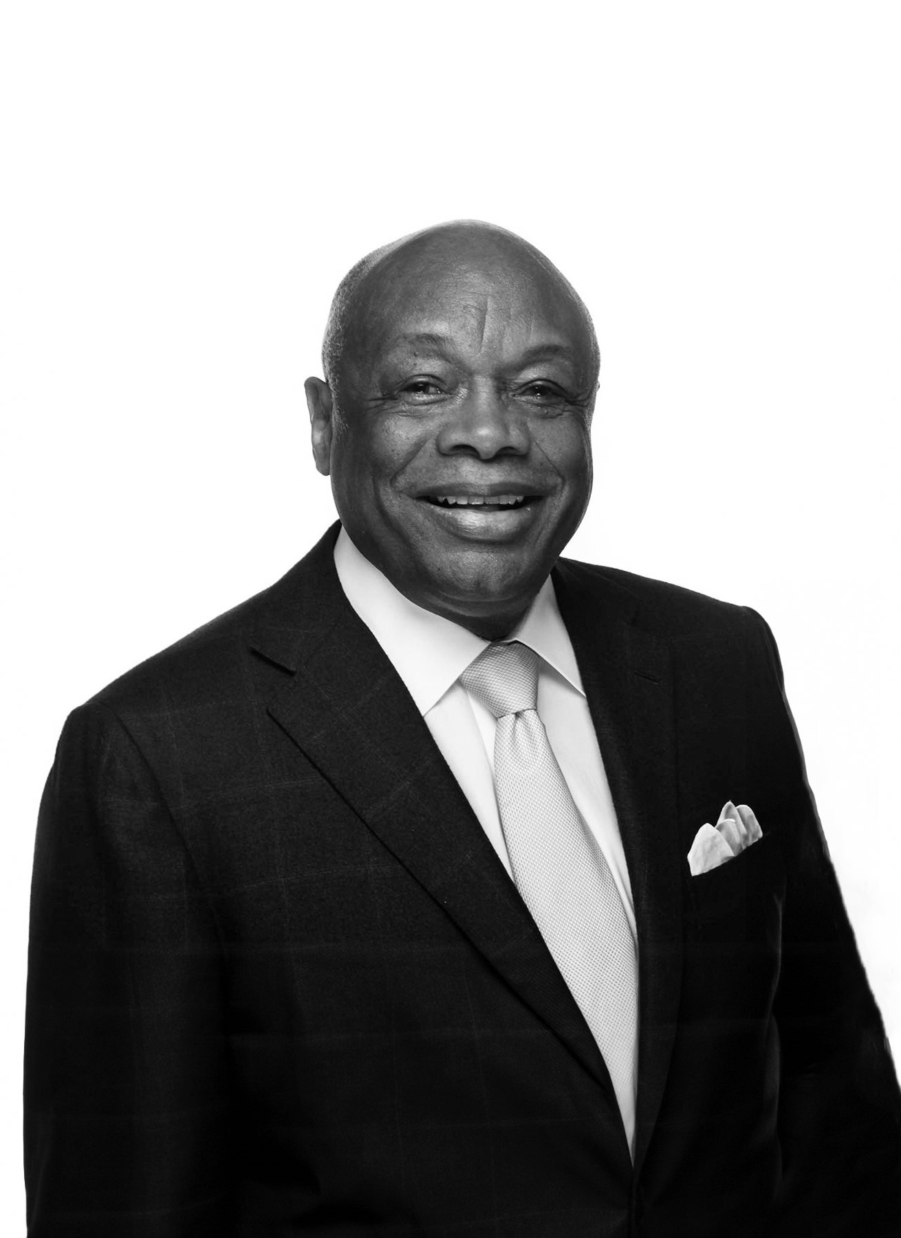Headshot of a smiling Willie L. Brown Jr. wearing a dark suit.