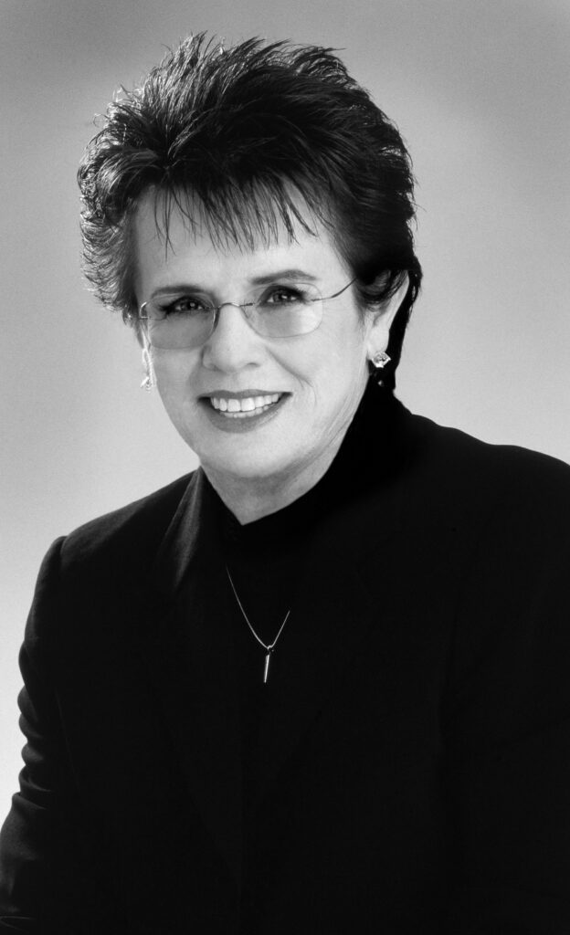 Headshot of a smiling and dressed-up Billie Jean King.