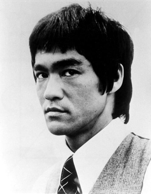 A young Bruce Lee gazes sternly while wearing a tie.