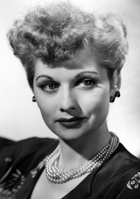 Headshot of a young, elegantly dressed Lucille Ball.