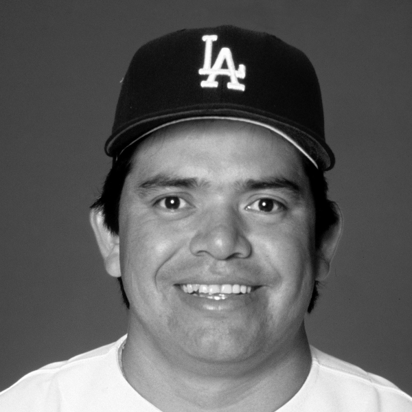 Headshot of Fernando Valenzuela wearing a Dodgers cap and jersey.