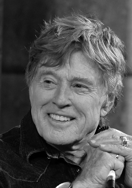 Robert Redford smiles and gazes to his right.