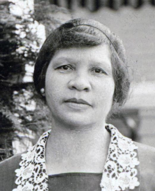 Headshot of Charlotta Bass with short hair and a lace-lined top.