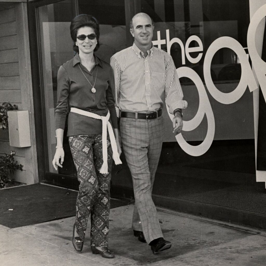 A young Doris and Donald Fisher walk past their GAP storefront.