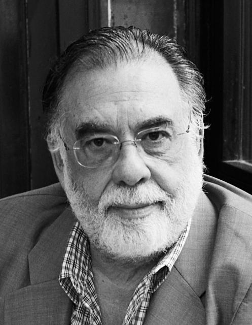 Headshot of Francis Coppola wearing a suit and glasses.