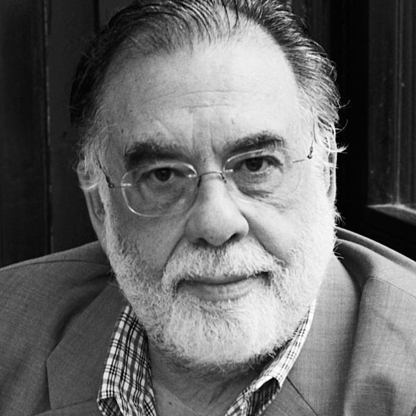 Headshot of Francis Coppola wearing a suit and glasses.