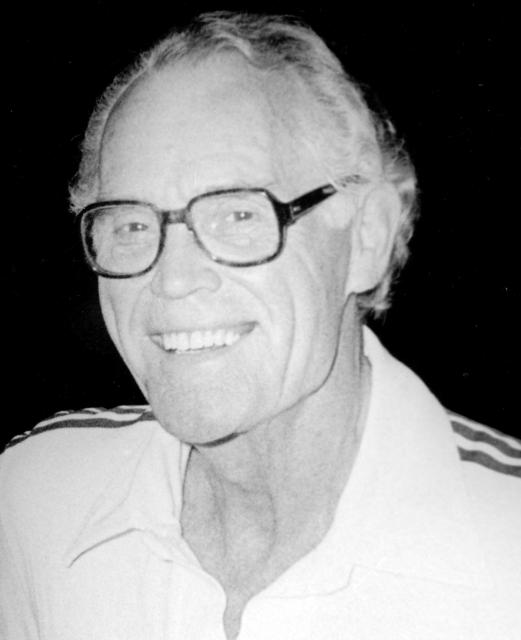 Headshot of a joyful Fred Ross Senior wearing glasses.