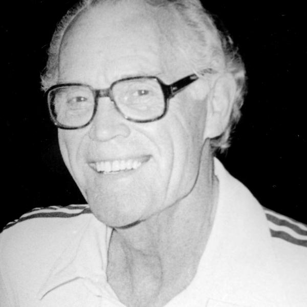 Headshot of a joyful Fred Ross Senior wearing glasses.