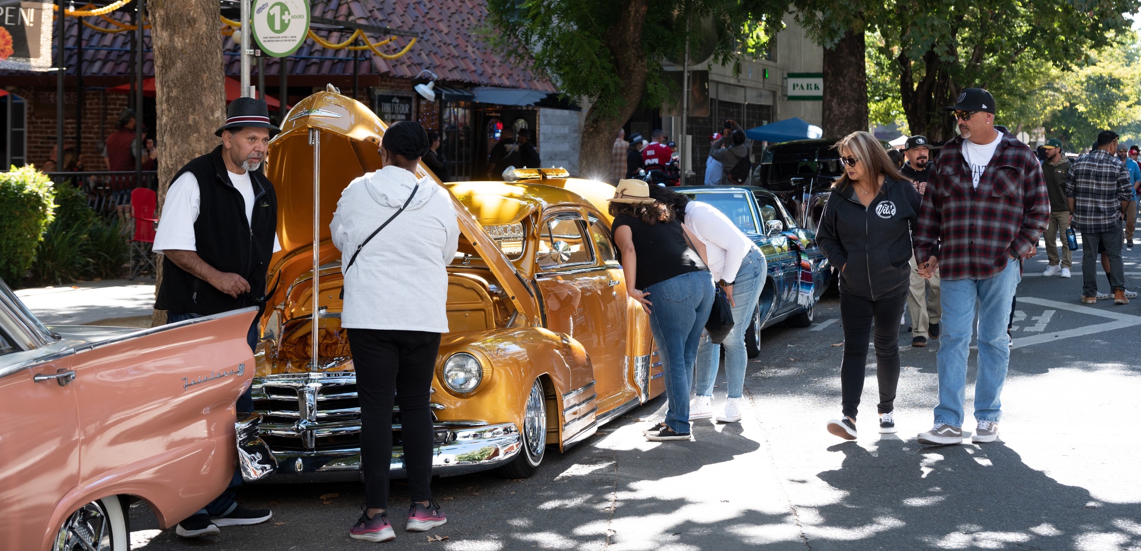 A group of people admiring classic cars.