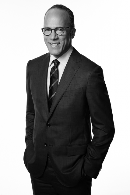 Lester Holt poses with a smile and hands in his suit pockets.