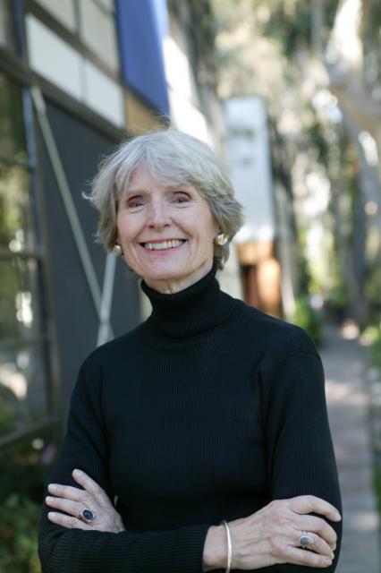 Women in a turtleneck sweater smiling.