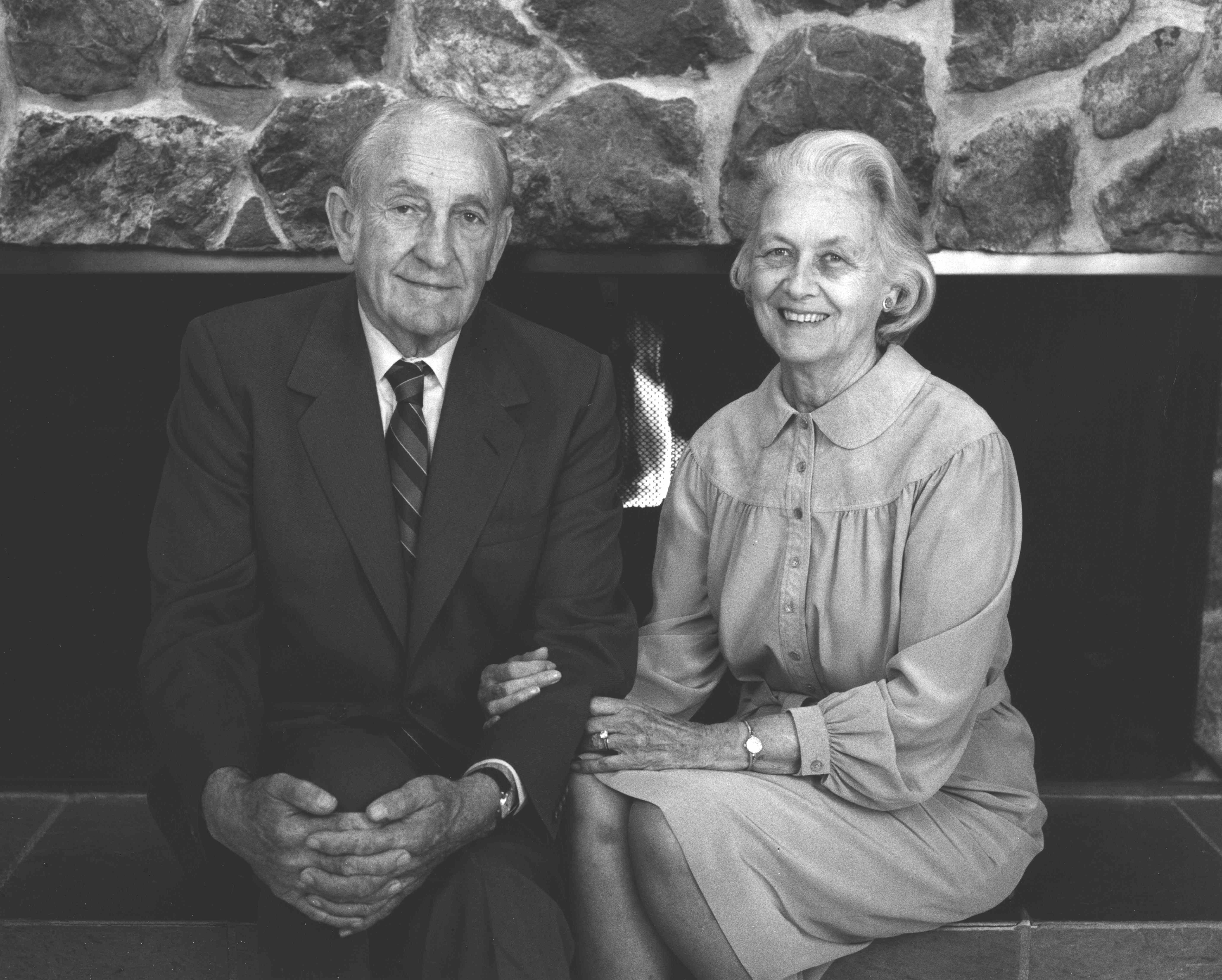 David and Lucile Packard sit together in front of a fireplace.