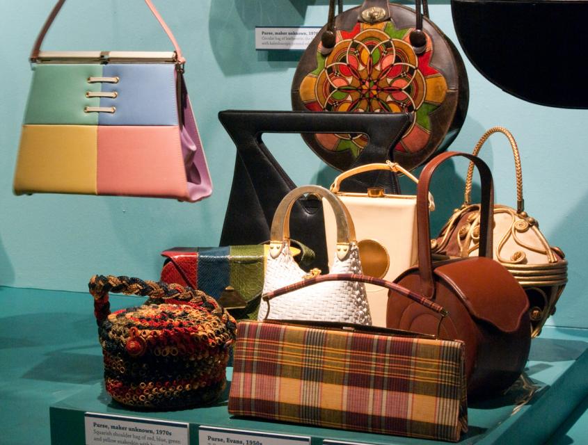 Several purses arranged in a display case.