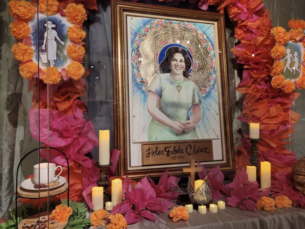 Dia de los Muertos altar honoring Helen Fabela Chavez with candles and marigolds