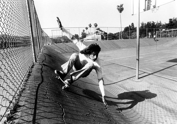 Skateboarder riding in a skatepark.