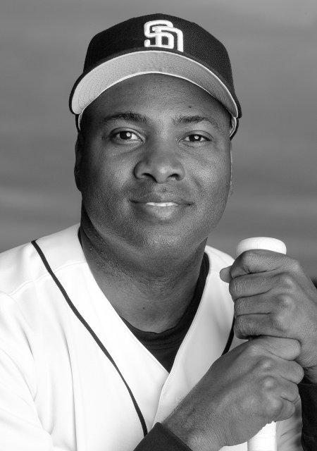 A young Tony Gwynn poses with his Padres cap, jersey, and bat.